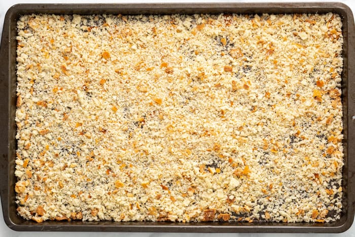 Homemade breadcrumbs on a baking sheet.