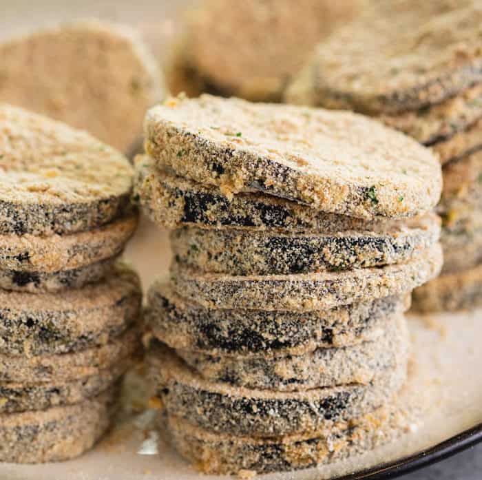 A tall stack of breaded eggplant slices. 