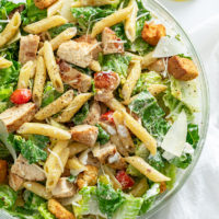 Chicken Caesar Pasta Salad in a glass bowl.