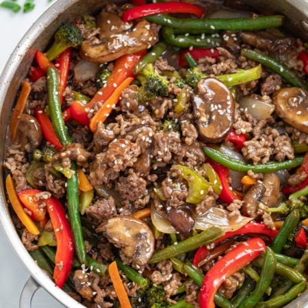 A skillet filled with Ground Beef Stir Fry with sesame seeds on top.