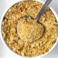 Homemade breadcrumbs in a bowl with a measuring spoon.