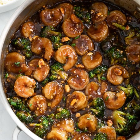 Honey Garlic Chicken in a skillet with a brown sauce and broccoli.