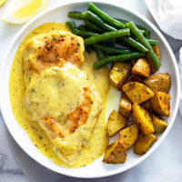 Honey Mustard Chicken on a plate with roasted potatoes and green beans.