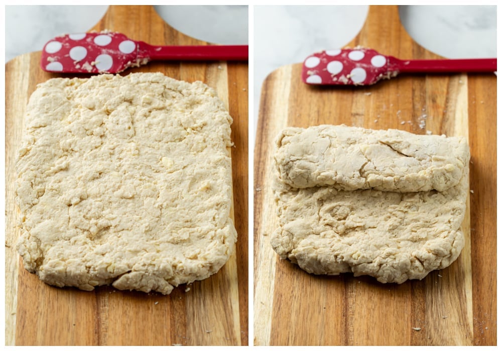 A wooden cutting board with Buttermilk Biscuit dough being rolled and folded.