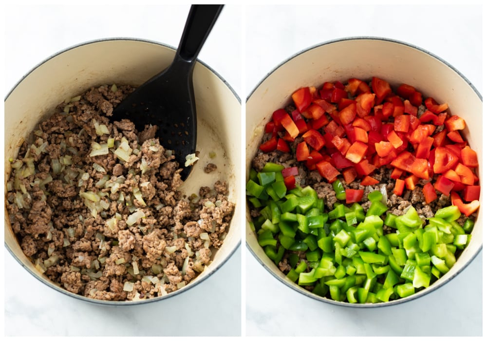 A soup pot filled with cooked ground beef and onions with green and red bell peppers being added for stuffed pepper soup.