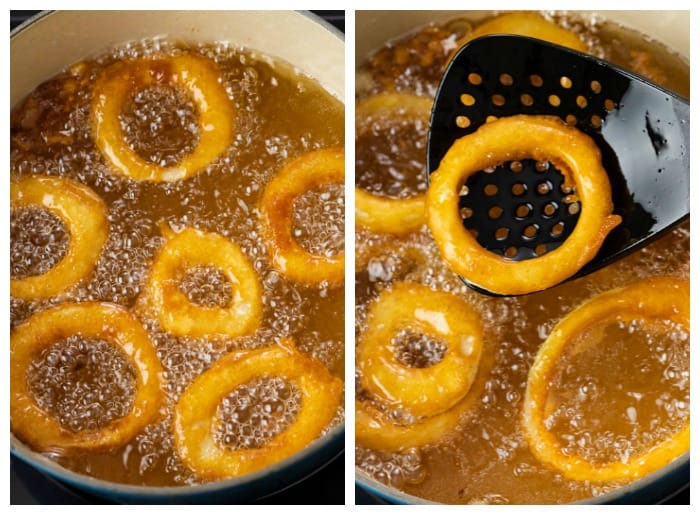 A dutch oven filled with deep fried onion rings frying in oil.