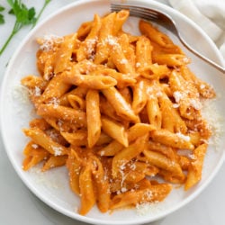 Pink Sauce Pasta on a white plate with grated Parmesan on top.