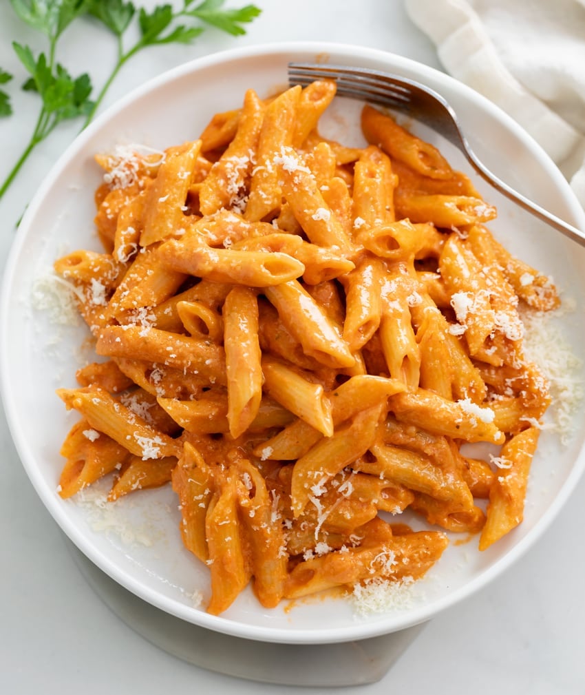 Pink Sauce Pasta on a white plate with grated Parmesan on top.