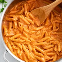 Pink Sauce Pasta in a skillet with a wooden spoon.