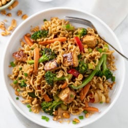 Ramen Noodle Stir Fry with Chicken and vegetables in sauce with a fork on the side.