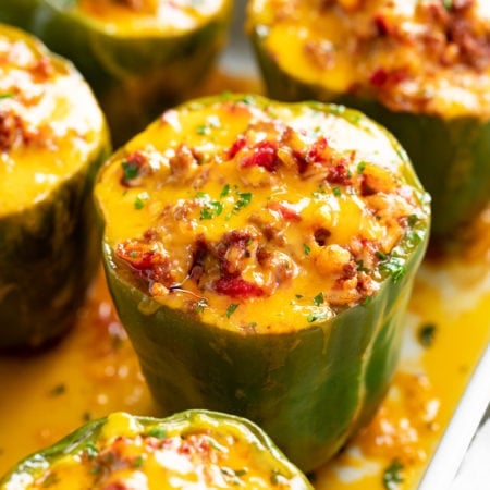 Stuffed Bell Peppers in a Casserole dish with meat and cheese.