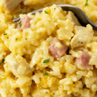 A fork scooping up Chicken Cordon Bleu Casserole with Rice.